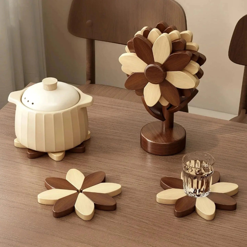 Image d'un dessous de plat en bois de couleur brun et beige en forme de tournesol sur une table en bois brun avec un verre de liquide et un plat avec couvercle